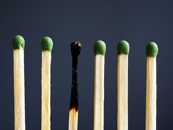 a row of matches, one of which is burned